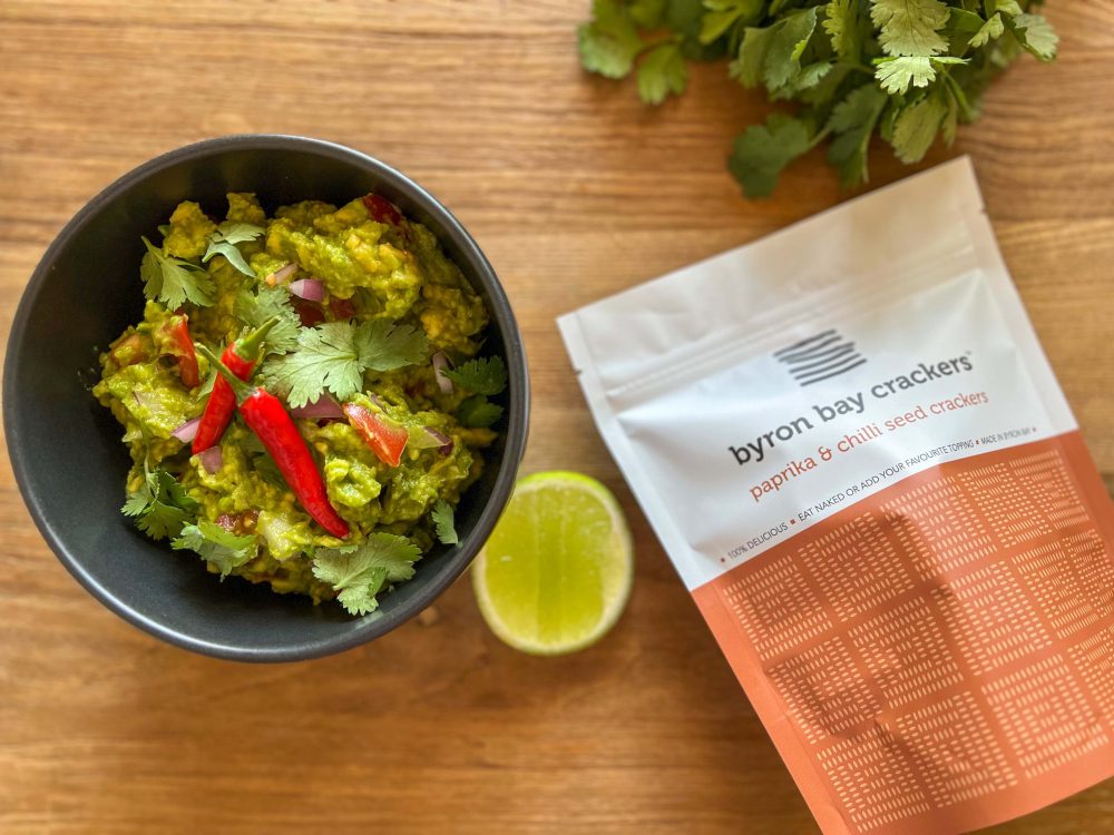 Bowl of guacamole with Byron Bay Crackers paprika and chilli pouch